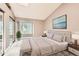 Staged bedroom showcasing calming decor, a queen bed, and a bright window view at 11155 W 17Th Ave # 103, Lakewood, CO 80215