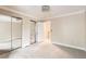 Large bedroom featuring a mirrored closet, carpet, and an open doorway at 11155 W 17Th Ave # 103, Lakewood, CO 80215