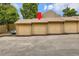 Multiple attached garages with brown doors provide plenty of parking at 11155 W 17Th Ave # 103, Lakewood, CO 80215