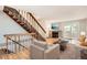 Living room with hardwood floors, fireplace, stairs, and comfortable furniture, a cozy interior setting at 11155 W 17Th Ave # 103, Lakewood, CO 80215