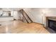 Bright, spacious living room featuring hardwood floors, a staircase, and fireplace, great for gatherings at 11155 W 17Th Ave # 103, Lakewood, CO 80215