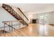 Light-filled living area with hardwood floors, brick fireplace, and stairs leading to an upper level at 11155 W 17Th Ave # 103, Lakewood, CO 80215
