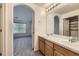 Bathroom featuring double sinks, vanity, archway and view of the bedroom at 3375 Boulder Cir # 204, Broomfield, CO 80023
