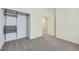 Well-lit bedroom with neutral carpet, featuring a closet and a doorway to the hallway at 3375 Boulder Cir # 204, Broomfield, CO 80023