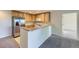 Bright kitchen featuring stainless steel appliances and wooden cabinets, perfect for cooking and entertaining at 3375 Boulder Cir # 204, Broomfield, CO 80023