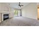 Open living room boasts carpeting, a fireplace and flows onto a balcony, creating a cozy and bright atmosphere at 3375 Boulder Cir # 204, Broomfield, CO 80023