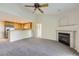 Spacious living room with vaulted ceilings, fireplace, ceiling fan, and open flow into the kitchen area at 3375 Boulder Cir # 204, Broomfield, CO 80023