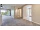 Bright living room featuring vaulted ceiling, fan, carpet and access to balcony at 3375 Boulder Cir # 204, Broomfield, CO 80023
