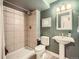 Bathroom features a tiled shower stall and a pedestal sink with neutral wall paint at 8367 Devinney St, Arvada, CO 80005