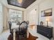 Elegant dining room features a rustic table with black chairs and ample natural light at 8367 Devinney St, Arvada, CO 80005