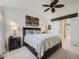 Bright main bedroom with vaulted ceiling, barn door access to the bathroom, and a comfortable bed at 8367 Devinney St, Arvada, CO 80005