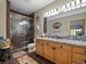 Bathroom featuring a glass shower, tile flooring, and double sink vanity with marble countertop at 23076 Oehlmann Park Rd, Conifer, CO 80433