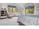 Bright bedroom features large windows with natural light and comfortable furnishings at 23076 Oehlmann Park Rd, Conifer, CO 80433