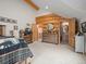 Bedroom boasting log accents, and ensuite bath access at 23076 Oehlmann Park Rd, Conifer, CO 80433