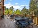 Outdoor patio area with dining tables and chairs overlooking the beautiful forest at 23076 Oehlmann Park Rd, Conifer, CO 80433