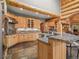 Open-concept kitchen features granite countertops, stainless steel appliances, wood cabinets and a breakfast bar at 23076 Oehlmann Park Rd, Conifer, CO 80433
