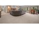 Spacious living room featuring a stone fireplace, a comfortable sectional, and beautiful backyard views at 23076 Oehlmann Park Rd, Conifer, CO 80433