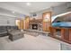 Cozy living room boasting a stone fireplace, built-in cabinets, and comfortable seating at 23076 Oehlmann Park Rd, Conifer, CO 80433