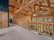 This large and open loft area features log beams and railing overlooking the floor below at 23076 Oehlmann Park Rd, Conifer, CO 80433