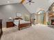 Bright main bedroom features vaulted ceilings, a stone fireplace, and a private balcony at 23076 Oehlmann Park Rd, Conifer, CO 80433