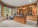 Cozy office space with custom built-ins, carpet and large windows for natural light and backyard view at 23076 Oehlmann Park Rd, Conifer, CO 80433