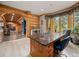 Spacious office with large granite desktop, wood cabinets and view of the log home's grand interior at 23076 Oehlmann Park Rd, Conifer, CO 80433