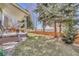 A well maintained lawn features a back porch with outdoor seating and mature trees at 17798 E Ida Ave, Centennial, CO 80015