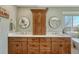 Double sink bathroom vanity with wooden cabinetry and matching framed mirrors at 17798 E Ida Ave, Centennial, CO 80015