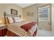 Cozy bedroom with a wrought iron bed frame, a window, soft lighting, and decor creates a relaxing retreat at 17798 E Ida Ave, Centennial, CO 80015