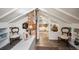 Cozy attic with a view into another room, featuring brick detail and unique decor at 3242 Utica St, Denver, CO 80212