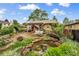 Charming backyard oasis featuring a lovely pond, flagstone patio, pergola, and lush landscaping at 3242 Utica St, Denver, CO 80212