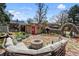 Inviting backyard with a stone patio, outdoor seating, a fire pit, and charming landscaping at 3242 Utica St, Denver, CO 80212