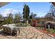 Backyard featuring patio seating, a charming stone pathway, and lush landscaping at 3242 Utica St, Denver, CO 80212