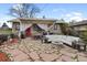 Spacious backyard patio with comfortable seating, a fire pit, and a rustic dining area at 3242 Utica St, Denver, CO 80212