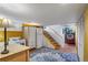 Basement featuring kitchenette, laundry area, tile flooring, and stairs to the upper level at 3242 Utica St, Denver, CO 80212