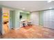 Basement office with tile floors, built-in desk, and storage cabinets at 3242 Utica St, Denver, CO 80212