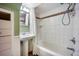 Bright bathroom features a pedestal sink, tiled shower, and a decorative mirror at 3242 Utica St, Denver, CO 80212
