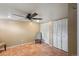 Bedroom featuring a ceiling fan, tile flooring, and ample closet space at 3242 Utica St, Denver, CO 80212