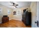 Bright bedroom features hardwood floors, ceiling fan, and a chandelier for a cozy feel at 3242 Utica St, Denver, CO 80212