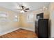 Cozy bedroom with hardwood floors, ample natural light from two windows, and a modern ceiling fan at 3242 Utica St, Denver, CO 80212