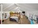 Finished attic space with built-in shelving and wood floors providing ample storage at 3242 Utica St, Denver, CO 80212