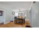 Simple dining area with hardwood floors, table, bench and a view out the window at 3242 Utica St, Denver, CO 80212
