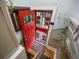 Unique entryway with red door, security gate, and custom painted murals on walls at 3242 Utica St, Denver, CO 80212