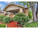 Inviting brick home showcasing a cozy front porch and lush landscaping at 3242 Utica St, Denver, CO 80212