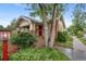 Charming exterior of a brick home with a covered front porch and well-maintained landscaping at 3242 Utica St, Denver, CO 80212