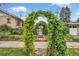 Charming front yard featuring vine-covered arches leading to a private garden at 3242 Utica St, Denver, CO 80212