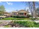 Charming brick home with a well-maintained lawn, a red door, and lush landscaping at 3242 Utica St, Denver, CO 80212