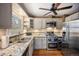 Well-lit kitchen with granite countertops, stainless steel appliances, and hardwood floors at 3242 Utica St, Denver, CO 80212
