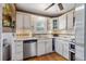 Bright kitchen with white cabinets, stainless steel appliances, granite countertops, and hardwood floors at 3242 Utica St, Denver, CO 80212