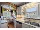 Charming kitchen nook with granite countertops, mosaic tile backsplash, and a stainless steel sink at 3242 Utica St, Denver, CO 80212